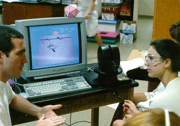 Mike Falvo 
shows student how to use nanoManipulator (Photo by Kevin Jeffay)