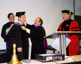 Dr. Mark Livingston receives his Ph.D. hood from Dr. Kevin Jeffay 
(left) and Dr. Henry Fuchs (Photo by Claire Stone)