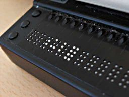 Refreshable Braille display has an array of tiny moving pins to form Braille letters.